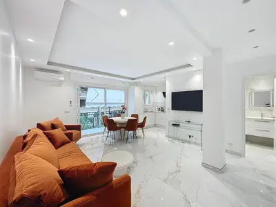 a living room with a couch and a table at Executive 2BR Apartment near Croisette Ideal for MIPIM Terrace & Wi-Fi in Cannes