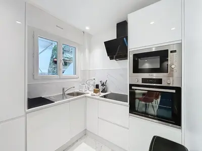 a living room with a white table and chairs at Executive 2BR Apartment near Croisette Ideal for MIPIM Terrace & Wi-Fi in Cannes