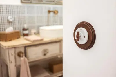 a bathroom with a sink and a clock on the wall at Charmant studio dans la Californie in Cannes