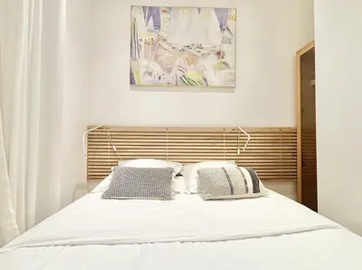 a bedroom with a white bed with two pillows at Cannes One Bedroom Apartment - 85M in Cannes
