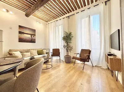a living room with a couch and a table and chairs at Cannes One Bedroom Apartment - 85M in Cannes