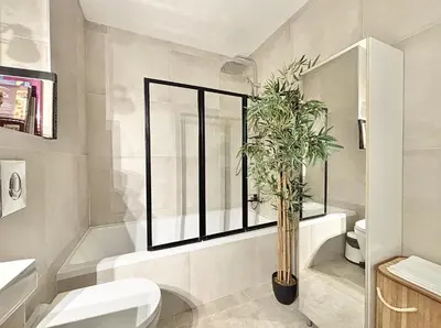 a bathroom with a toilet and a potted plant at Cannes One Bedroom Apartment - 85M in Cannes
