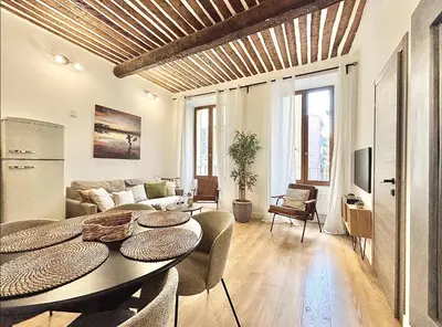 a living room with a table and a couch at Cannes One Bedroom Apartment - 85M in Cannes