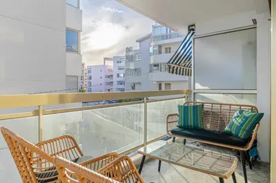 a balcony with two chairs and an american flag at Elegant apt with balcony near the beaches – Cannes in Cannes
