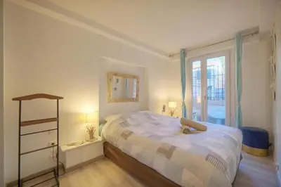 a bedroom with a large bed and a window at Cannes Sunset & Sea Apartment in Cannes