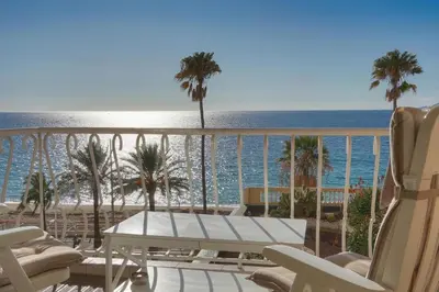 a view of the beach from the balcony of a resort at Cannes Sunset & Sea Apartment in Cannes