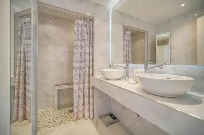 a bathroom with two sinks and a shower at Cannes Sunset & Sea Apartment in Cannes