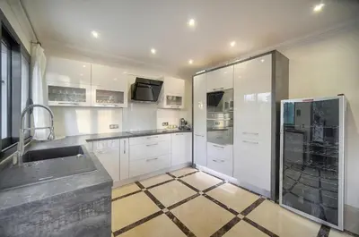 a kitchen with white cabinets and a sink at FRGK Villa Contemporaine Studio Indépendant Piscine, Calme Vue Dégagée in Le Cannet
