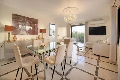 a living room with a glass table and chairs at FRGK Villa Contemporaine Studio Indépendant Piscine, Calme Vue Dégagée in Le Cannet