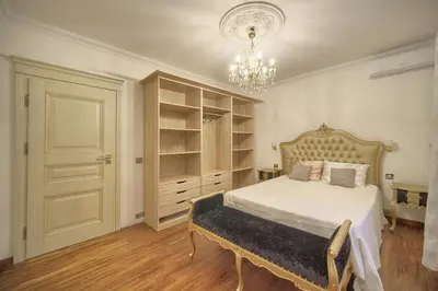 a bedroom with a bed and a chandelier at FRGK Villa Contemporaine Studio Indépendant Piscine, Calme Vue Dégagée in Le Cannet