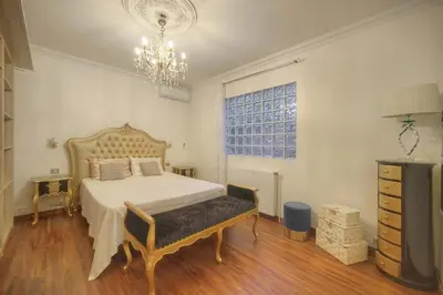 a bedroom with a bed and a chandelier at FRGK Villa Contemporaine Studio Indépendant Piscine, Calme Vue Dégagée in Le Cannet