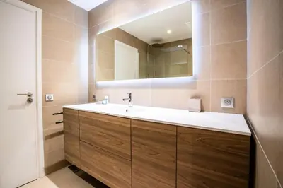a bathroom with a sink and a mirror at Résidence 3p De Style, Résidence Sécurisée Sur La Croisette - 3P de style, résidence sécurisée sur la Croisette MAE-1993 in Cannes