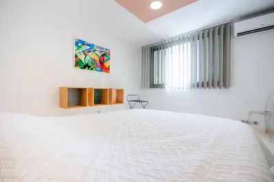 a white bedroom with a large white bed at Résidence 3p De Style, Résidence Sécurisée Sur La Croisette - 3P de style, résidence sécurisée sur la Croisette MAE-1993 in Cannes