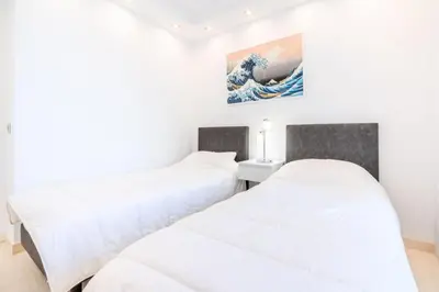 two beds in a room with white walls at Résidence 3p De Style, Résidence Sécurisée Sur La Croisette - 3P de style, résidence sécurisée sur la Croisette MAE-1993 in Cannes