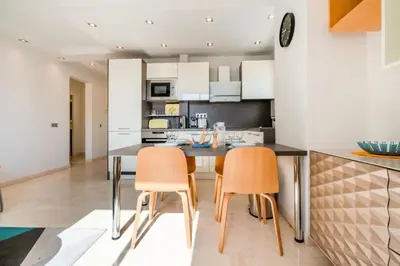 a kitchen with a dining table and two chairs at Résidence 3p De Style, Résidence Sécurisée Sur La Croisette - 3P de style, résidence sécurisée sur la Croisette MAE-1993 in Cannes