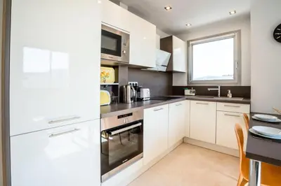 a kitchen with white cabinets and a window at Résidence 3p De Style, Résidence Sécurisée Sur La Croisette - 3P de style, résidence sécurisée sur la Croisette MAE-1993 in Cannes