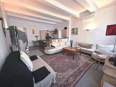 a large living room with couches and a table at le Festivalier - spacieux, bien équipé, piéton in Cannes
