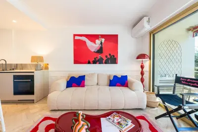 a living room with a couch and a table at 3-Br Apartment Sea View Terrace & Parking in Cannes