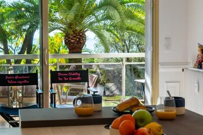 a table with fruit and oranges on it with a window at 3-Br Apartment Sea View Terrace & Parking in Cannes