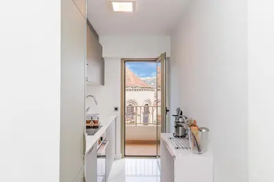 a white kitchen with a view of a building at 5 Croisette 6 in Cannes