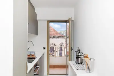 a kitchen with a door leading to a balcony at 5 Croisette 6 in Cannes