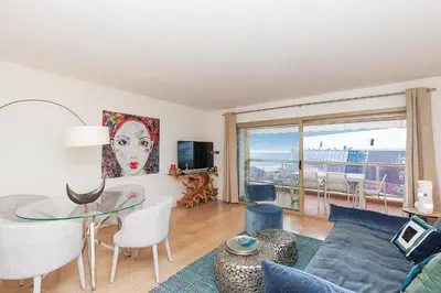 a living room with a glass table and chairs at 5 Croisette 6 in Cannes