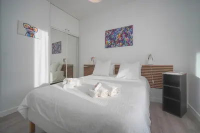 a bedroom with a white bed with towels on it at MAISON DE VILLE 6 Chambres TERRASSE -Stanislas Chic A6B002 in Cannes