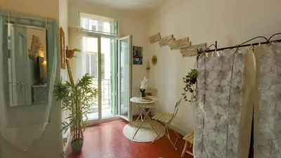 a bathroom with a shower and a table and a window at Studio Forville in Cannes