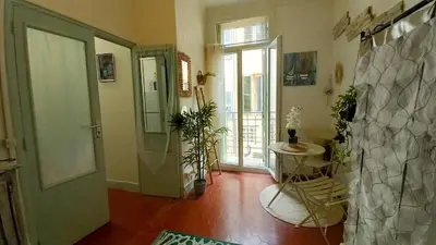 a room with a hallway with a door and a table at Studio Forville in Cannes