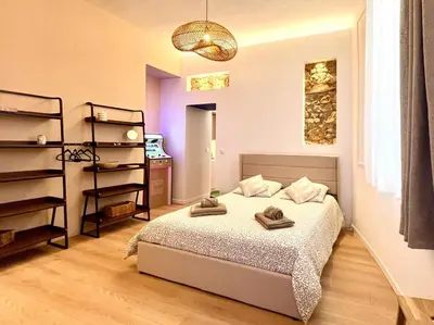 a bedroom with a bed with two towels on it at Le Borniol in Cannes