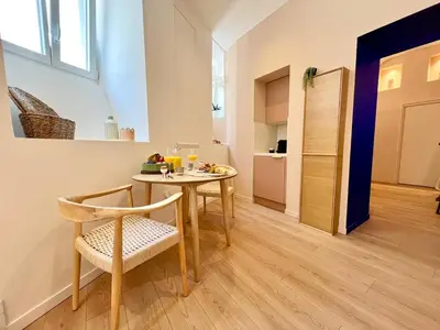 a dining room with a table and a chair at Le Borniol in Cannes