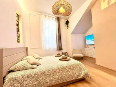 a bedroom with a large bed and a window at Le Borniol in Cannes