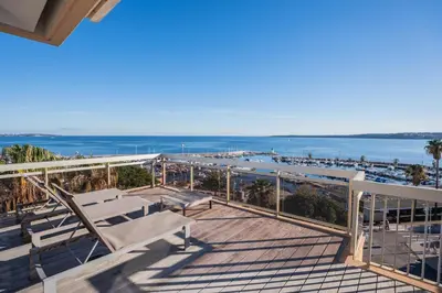 a balcony with chairs and a view of the water at REF 2033 - Cannes - Sumptuous penthouse with sea view for rent in Cannes