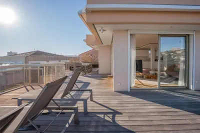 a row of chairs sitting on a wooden deck at REF 2033 - Cannes - Sumptuous penthouse with sea view for rent in Cannes