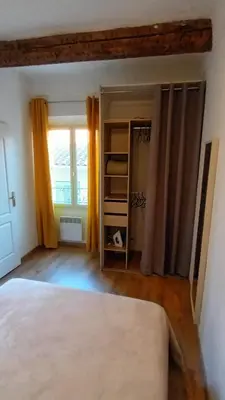 a bedroom with a bed with two gold pillows at Ideal for MIPIM Compact Executive Apartment Walk to Palais Suquet in Cannes