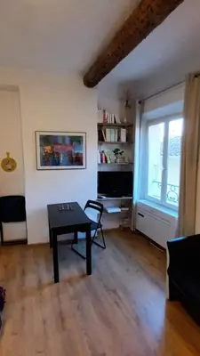 a living room with a table and a window at Ideal for MIPIM Compact Executive Apartment Walk to Palais Suquet in Cannes