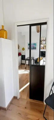 a hallway with a door leading to a living room at Ideal for MIPIM Compact Executive Apartment Walk to Palais Suquet in Cannes