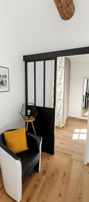 a living room with a black chair and a yellow pillow at Ideal for MIPIM Compact Executive Apartment Walk to Palais Suquet in Cannes