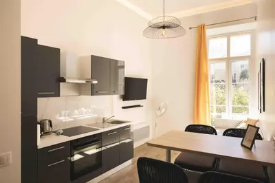 a kitchen with a table and a dining room at T2 Cozy Cannes 4 people Near Suquet in Cannes