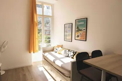 a living room with a couch in front of a window at T2 Cozy Cannes 4 people Near Suquet in Cannes