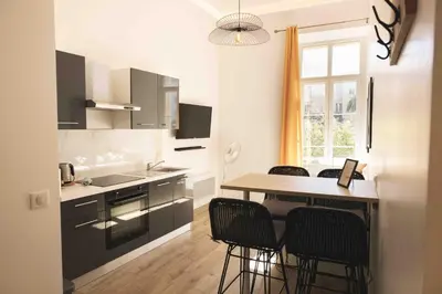 a kitchen with a table and chairs and a counter at T2 Cozy Cannes 4 people Near Suquet in Cannes