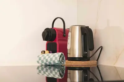 a coffee maker sitting on a stand next to aether at T2 Cozy Cannes 4 people Near Suquet in Cannes