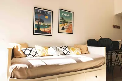 a bed in a room with two posters on the wall at T2 Cozy Cannes 4 people Near Suquet in Cannes