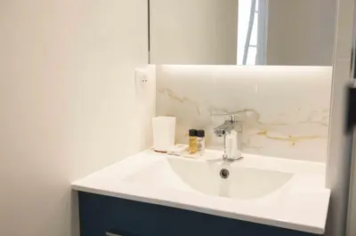 a bathroom with a white sink and a mirror at T2 Cozy Cannes 4 people Near Suquet in Cannes