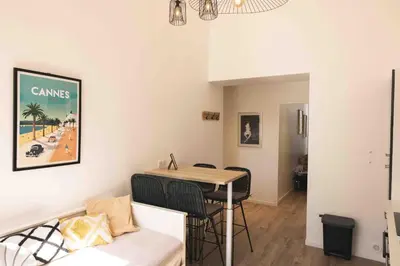 a living room with a table and a couch at T2 Cozy Cannes 4 people Near Suquet in Cannes