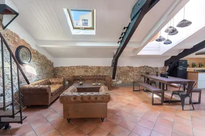 a bedroom with a bed and a large window at Le Borsalino Loft avec Tropezienne Suquet Cannes in Cannes