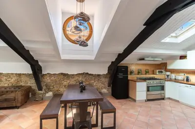 a kitchen with a table and a washing machine at Le Borsalino Loft avec Tropezienne Suquet Cannes in Cannes