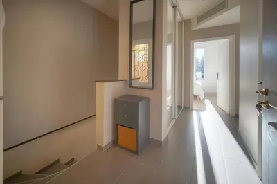 a hallway of a home with a staircase and a cabinet at DUPLEX 3 Chambres TERRASSE et 1 DEPENDANCE A4B026 in Cannes