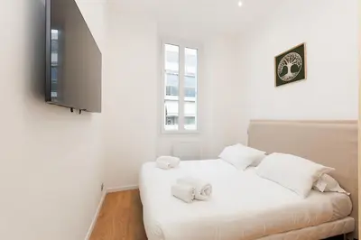 a bedroom with a white bed with towels on it at Immogroom - 1Bedroom - CityCenter - AC in Cannes