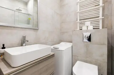 a white bathroom with a sink and a toilet at Immogroom - 1Bedroom - CityCenter - AC in Cannes